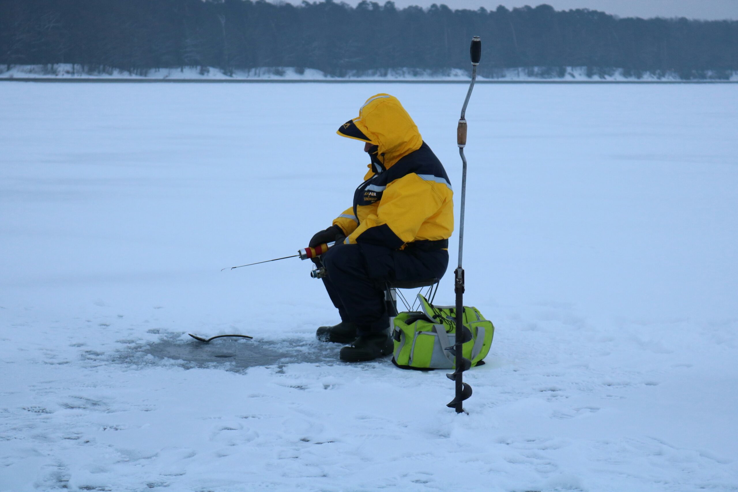 Man sitting and ice fishing
